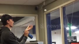 Office workers perfect their ping pong ball throwing skills