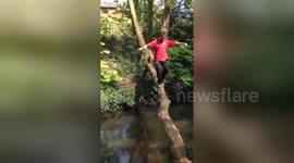 UK man falls in water trying to cross river on a log