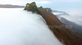 'Cloud waterfall' rolls down mountain in China