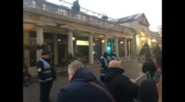 Apple fans receive pink wristbands as they wait to get new iPhone X