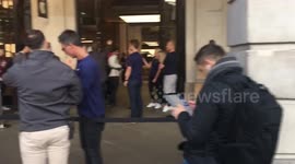 Apple employees applaud as first customers buy new iPhone X