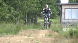 Man on bike crashing on the bikepark jump.