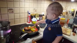 Little boy frying vegetables without help like a pro masterchief