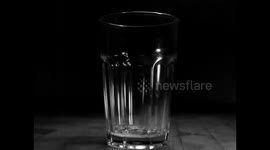 Slow motion water in glass with slow audio