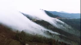'Cloud waterfall' rolls down mountain in southern China