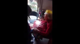 Child helps grandma open her Christmas present