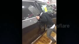 Car salesman gets head stuck when demonstrating door feature
