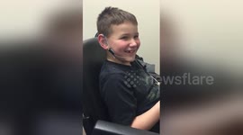 Boy, 7, smiles as he hears clearly for the first time