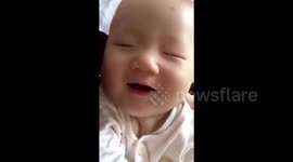 Dreaming baby laughs in his sleep