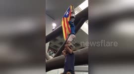 Girl climbs on top of human tower to unfurl Catalan pro-Independence flag