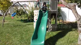 Two year old Batman going down slide and falls