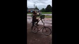 That's up-cycling! Cyclist 'avoids floods' with his double-decker bike