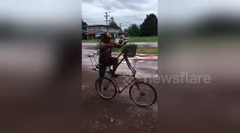 Cyclist avoids floods with his double-decker bike