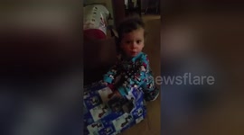 Newsflare Edit - Child is so Excited to Unwrap Gift That she Forgets how to Speak