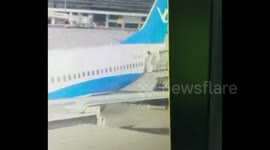 Flight attendant falls out of plane at China airport