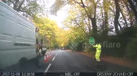 Making the most of your job: Construction worker in hi-vis dances while directing traffic
