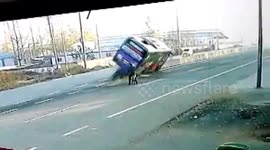 Coach trying to avoid cyclist crashes into central reservation and tips over
