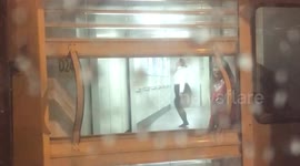 Passenger films BA ground crew member star jumping in gangway