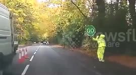 Man spotted dancing while holding 'stop' sign on British road