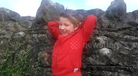 Boy struggles with jacket hood in Ophelia winds