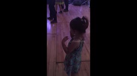 Little sister learning how to head bang at a wedding