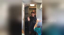 Flight attendants dance and sing during Southwest airlines flight