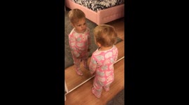 Cute baby in the mirror thinks it her friend