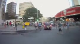 Pedestrian holds cyclist's back wheel so they can't move