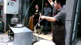 Chinese noodle master serves up SIXTY metre long noodles to delight of customers