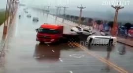 Multiple vehicles slide off car carrier in wet conditions