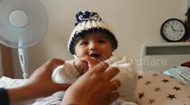 This six-month old baby smiles upon request