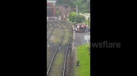 Child been swung over railway track