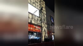 Blindfolded acrobat skips along moving ferris wheel
