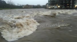 Huge waves roll over weir on River Kent, Kendal, Cumbria