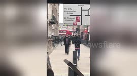 Newsflare Edit - Man walking backwards in London for no apparent reason (near parliament house)