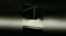 Freezing rain leaves ice sheet on car window