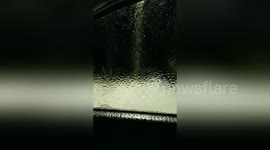 Freezing rain leaves ice sheet on car window