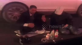 'Drunk' men block traffic as they dine in the middle of road