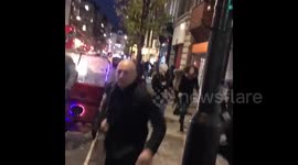Ground shot of people running from London's Oxford Circus