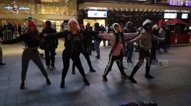 A group of Santa girls dancing in Leicester Square