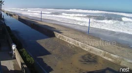 Surf crashing over Boardwalk sea wall in Mission Beach
