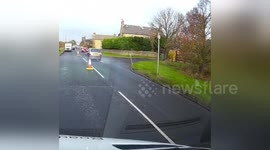 Driver nearly hits oncoming car on partially closed road