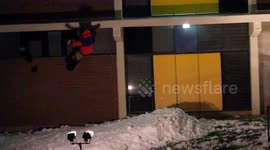 Snowboarder crashes and falls off building