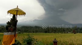 Newsflare Edit - Mount Agung Bali Volcano erupting by rice fields and house god.