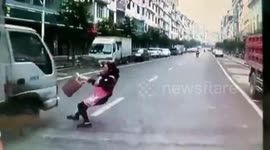 Woman crossing road narrowly escapes being run over by lorry
