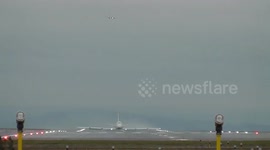 VIRGIN 747 crosswind takeoff with air traffic on finals from a stormy  manchester airport
