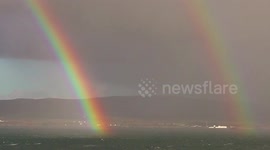 Stunning double rainbow above the sea in Scotland