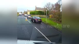 Driver nearly hits oncoming car on partially closed road