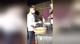 Young chef shows off meat cleaver spinning techniques