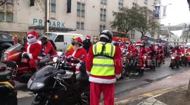 Hundreds of bikers ride through UK city dressed as Santa Claus